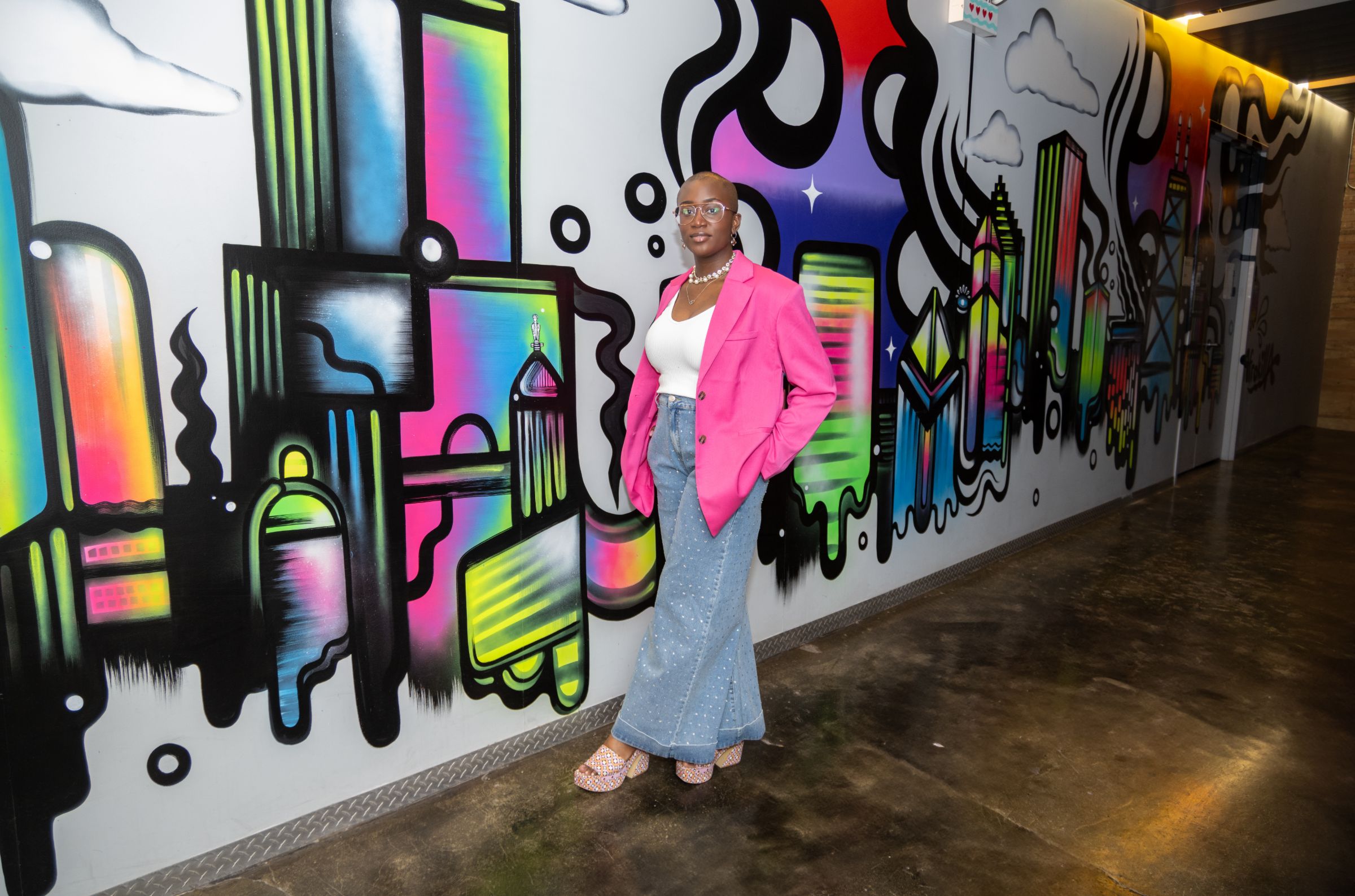 Junia Janvier in a pink blazer and wide-leg pants